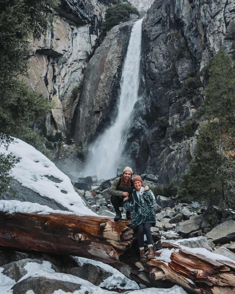 Emma and partner in front of waterfalls