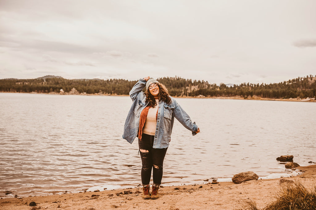 Taylor standing in front of a lake