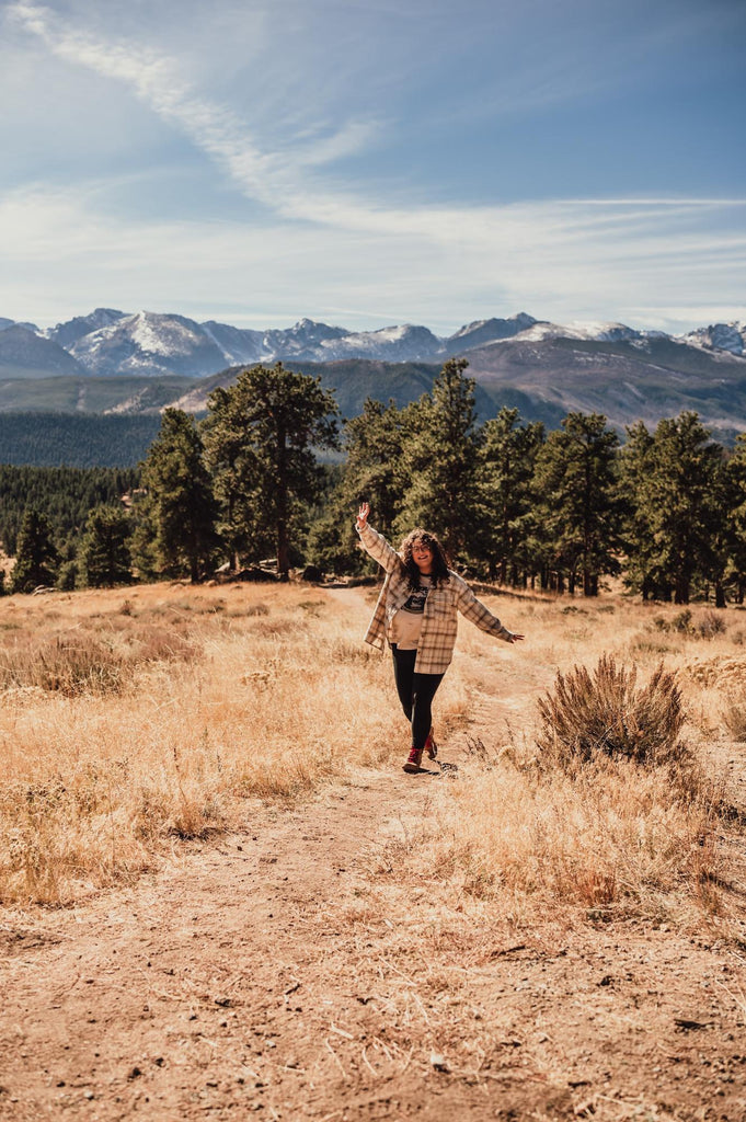 Taylor in the Shop Tee with the Rocky Mountains in the distance