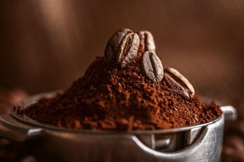 ground coffee poured into the holder on which the grains of roasted