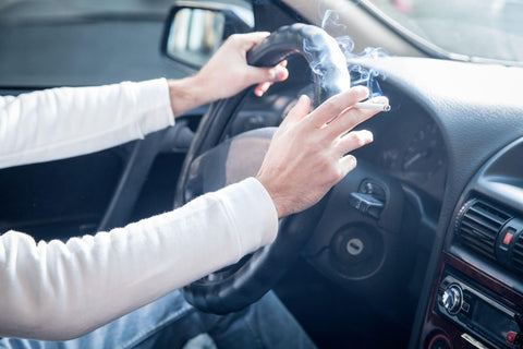 Man smoking a cigarette in a car