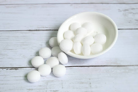 Mothballs in white bowl.