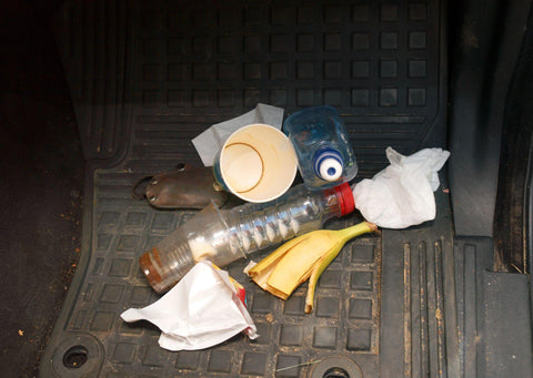 Trash on the floor of a car.