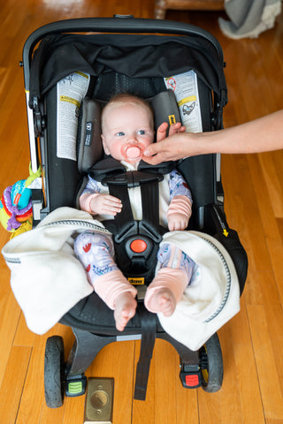Baby sleep sack with full zipper that allows for safe buckling in car seats.
