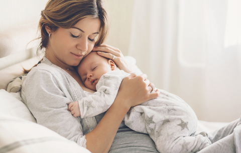 Mother holding sleeping baby