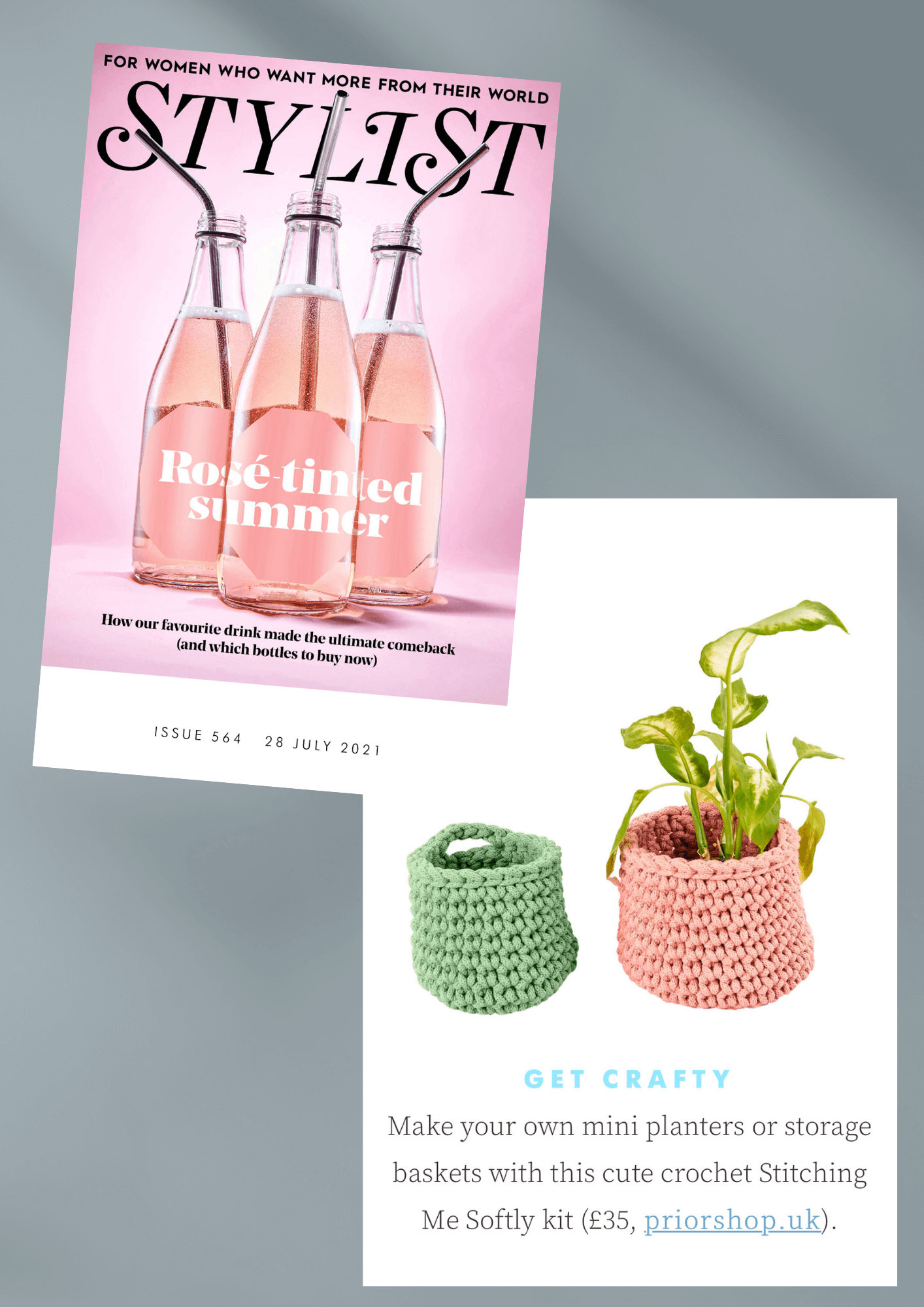 front cover of stylist magazine and 2 crochet baskets, one light green and the other pink. There is a plant in the pink one.