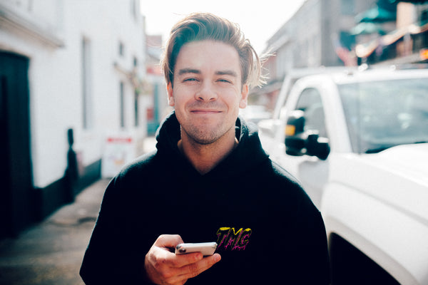 Cody Ko smiling while on his phone