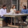 Faherty founders Alex, Kerry and Mike collaborating at a table outdoors