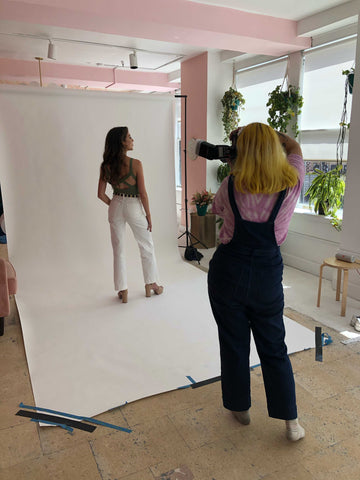 Photographer, Meg, photographs Frankly model on a seamless wall