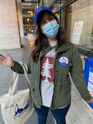 Heather, wearing a mask and her I Voted sticker at City Hall 