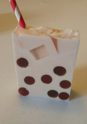 brown polka dotted soap with a striped straw