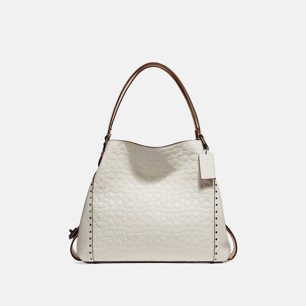 edie shoulder bag 31 in signature canvas with rivets