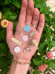 necklace charms in a hand 