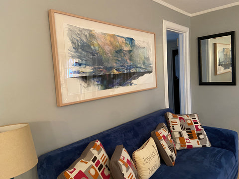 large painting over blue couch