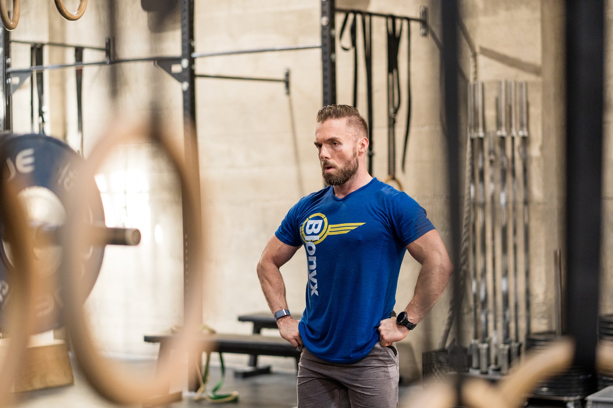 Man in a blue Blonyx shirt taking a break during a CrossFit workout