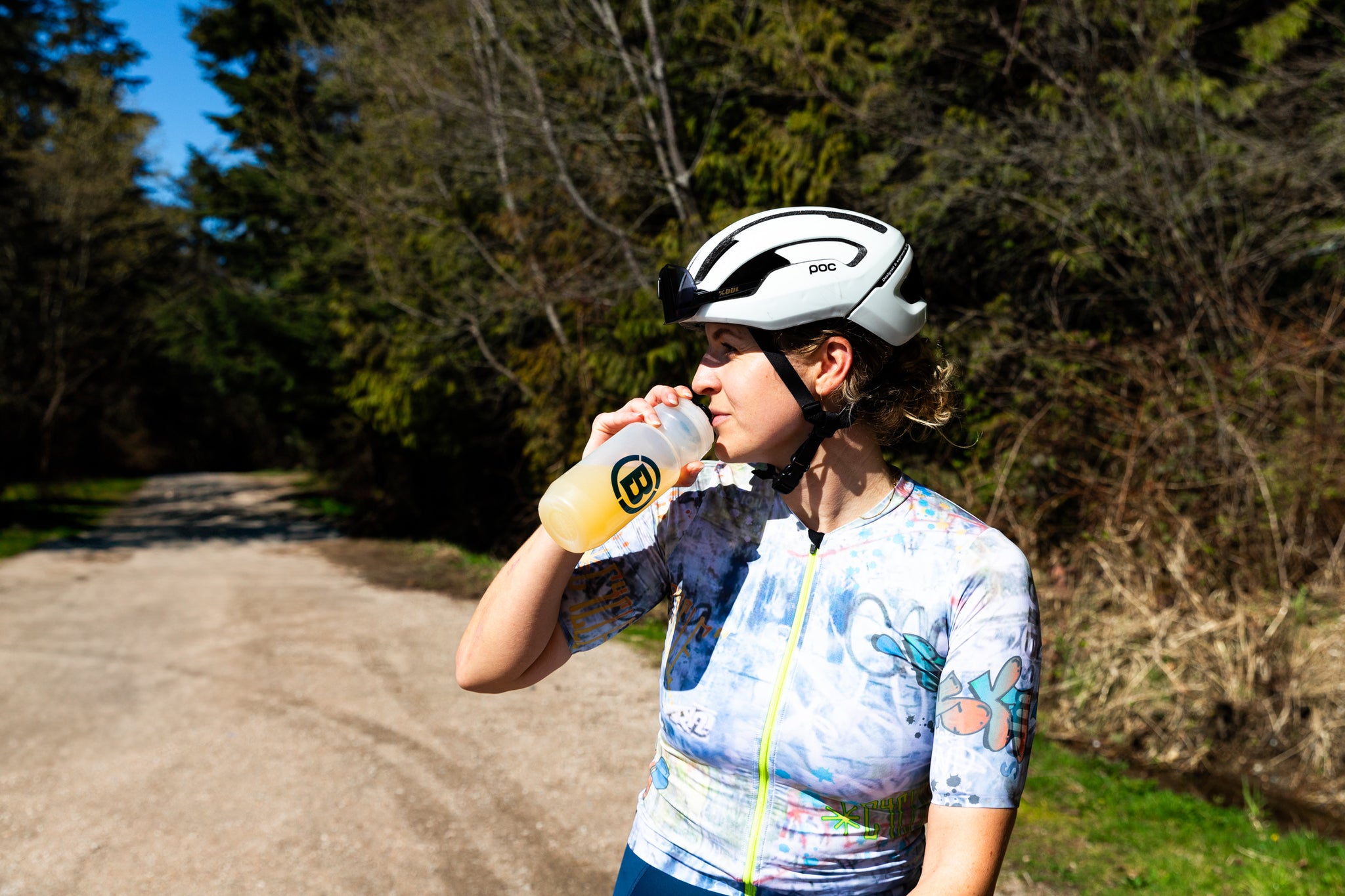 Cyclist sipping a bottle of Blonyx Hydra+