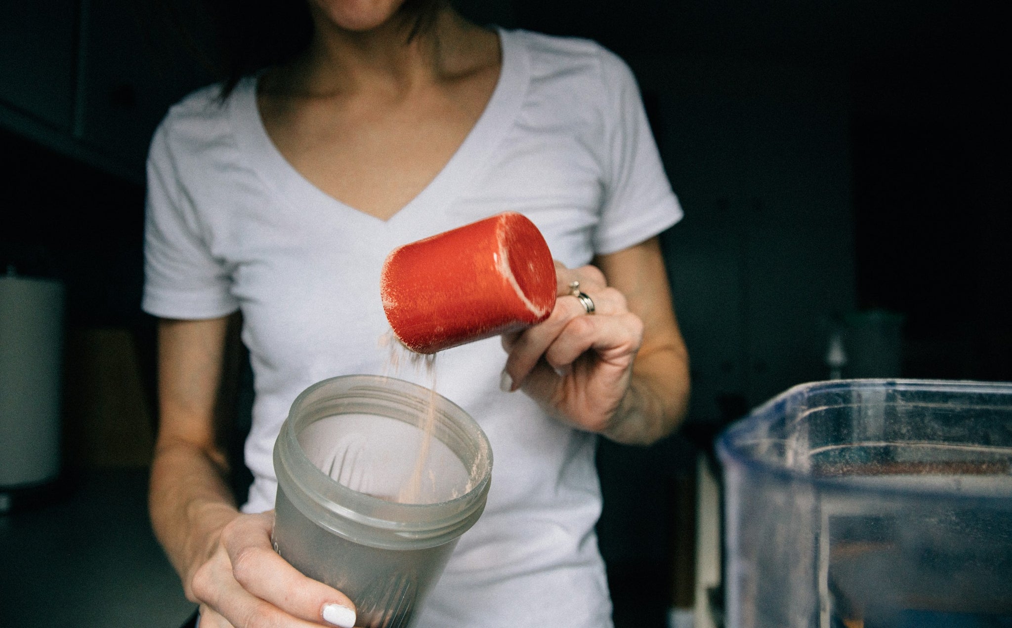 Woman scooping protein powder