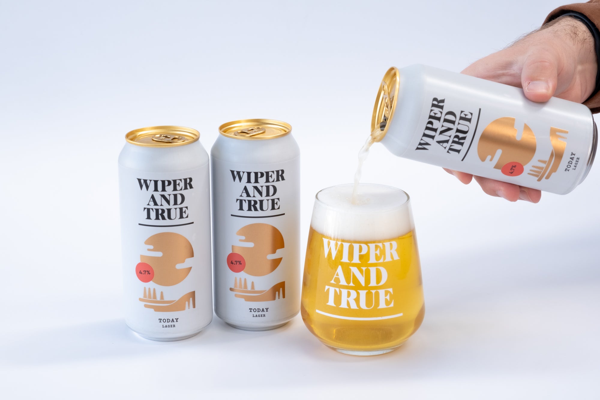 Two Wiper and True cans against a white background. A third can is being poured into a glass