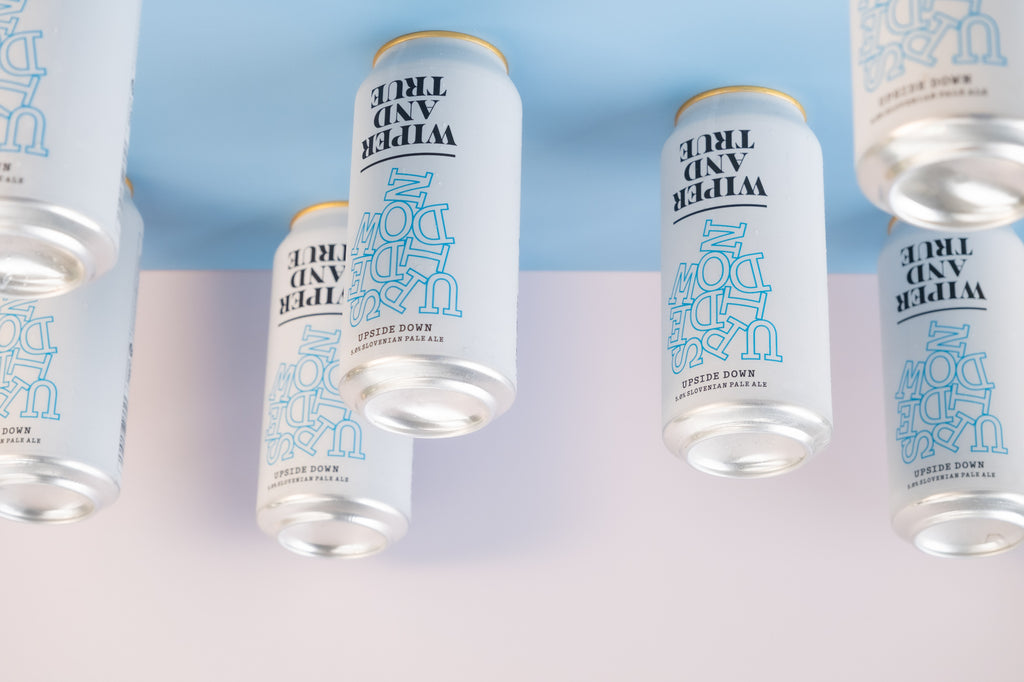 Upside Down cans of beer on a blue background