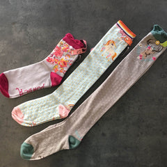 A photo showing three different length socks from Powder so show the difference in length between ankle, knee high and over the knee.