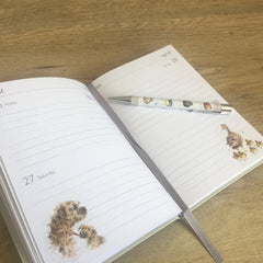 Photo of an open double page spread of the Wrendale Designs 2019 flexi diary. One of Wrendale's pens is sitting on top of the diary.