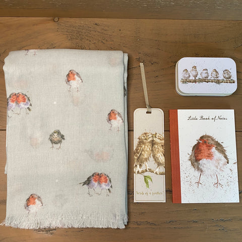 Wrendale Designs Bird themed letterbox gift comprising a robin scarf, owl bookmark, robin notebook and a little tin with a row of birds on it.