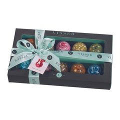 Picture of the box of 10 Visser Picasso Chocolates. The box is black with mint green ribbon. 10 Domed Chocolates can be seen in the box. They are each a different bright colour and have a splattered effect on them.