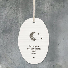 white porcelain engraved with a picture of a crescent moon and the text 'love you to the moon and back'