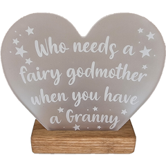 Acrylic heart with white text that reads 'who needs a fairy godmother when you have a granny' on a wooden base