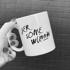 white mug with black text that reads 'yer some wummin'