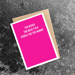 pink greeting card with white text that reads 'yer never too auld fir a cuddle fae yer mammy'