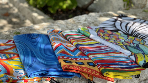 ECCOSOPHY sand free microfiber beach towels neatly folded after being washed.