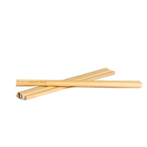 reusable bamboo straws sit on a white background