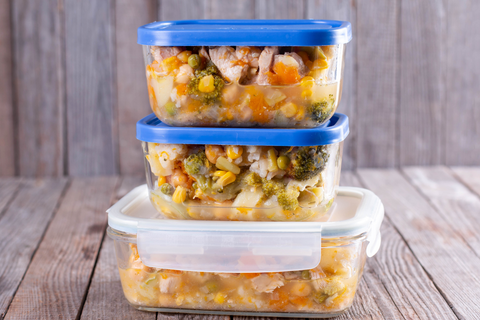 three containers with food sit on top of each other