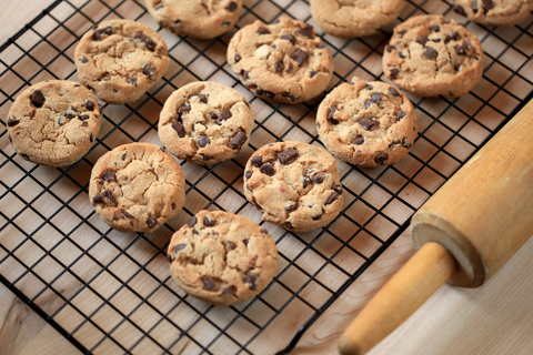 chocolate chip cookies sit on a cooling rack