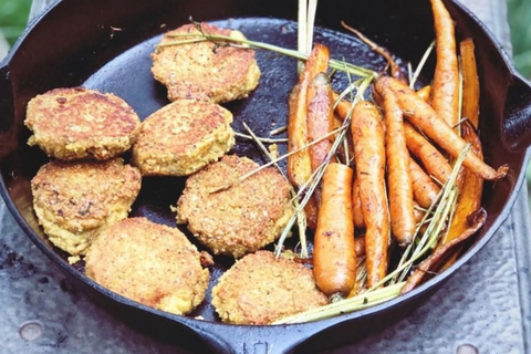 falafels are being cooked in a cast iron pan with carrots