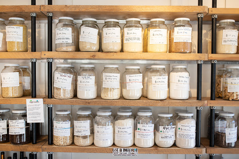 a wall of shelves with jars of bulk products