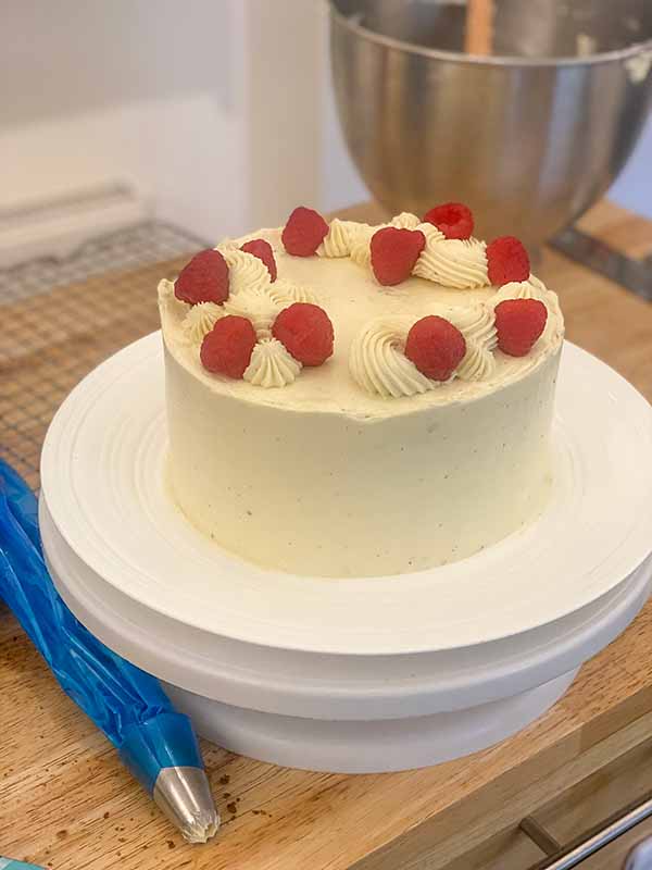 Decorating a simple birthday cake - with raspberries