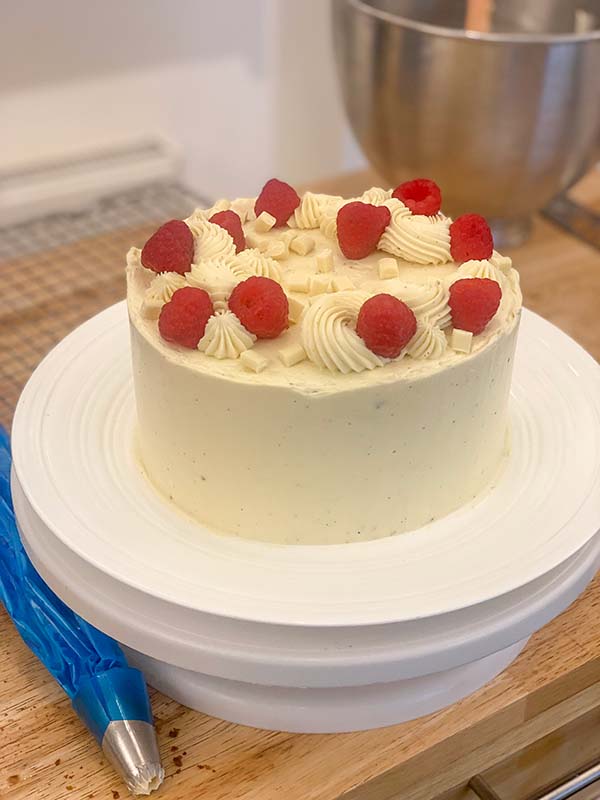 Decorating a simple birthday cake - with raspberries and white chocolate chips