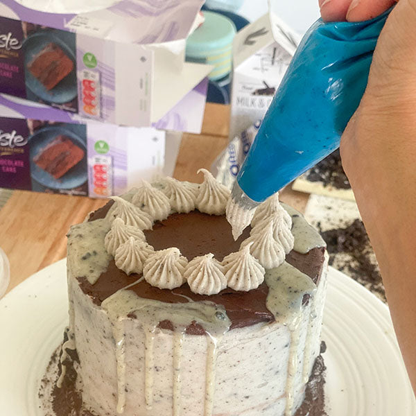 Fake Bakes Cookies and Cream Cake Recipe - pipe frosting swirls