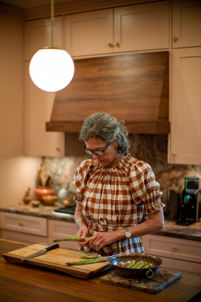 Woman preparing asparagus in the kitchen