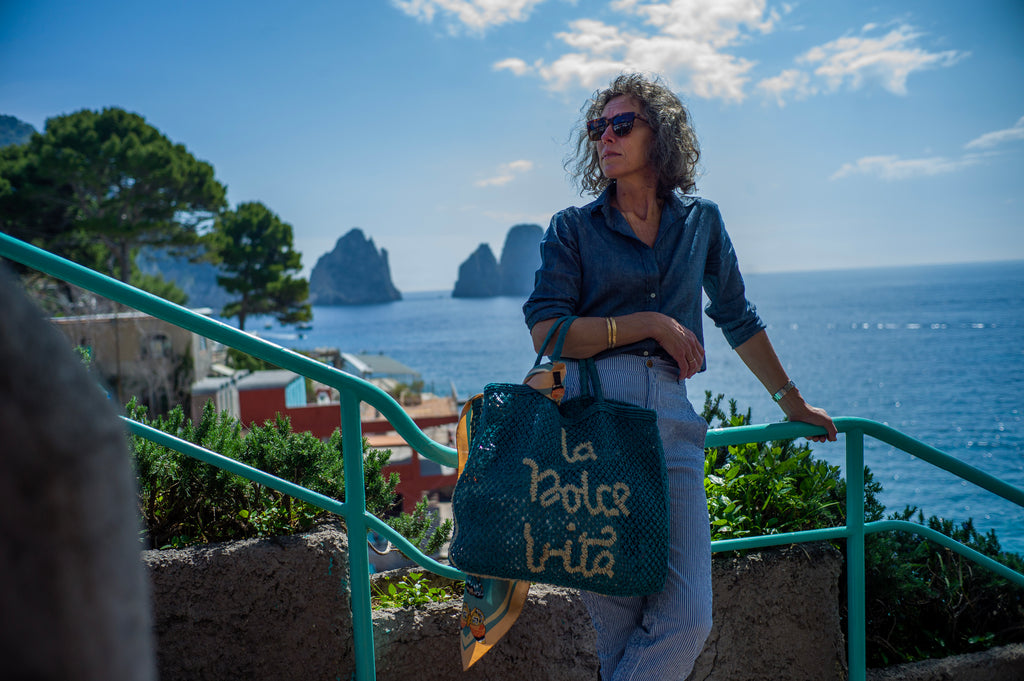 Woman standing on staircase on Capri coastline