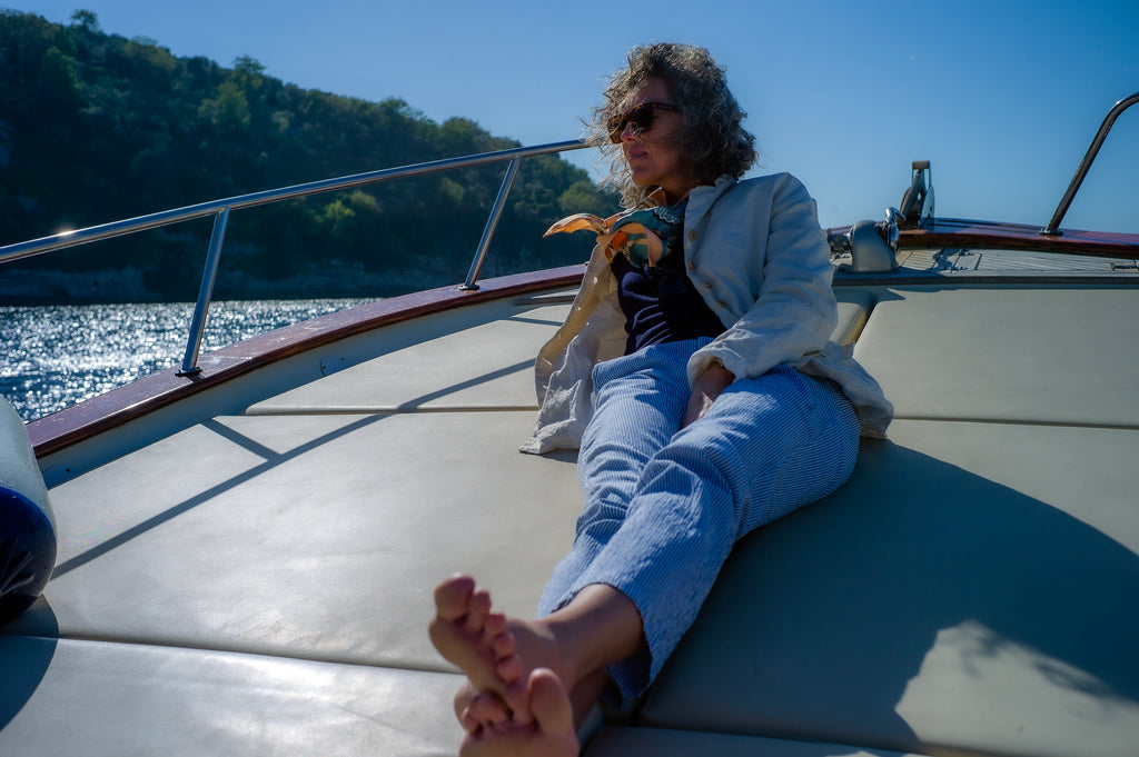 Woman lounging on the deck of a boat out at sea