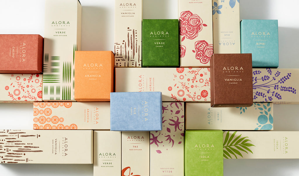 Alora diffuser and candle boxes placed in a geometric pattern