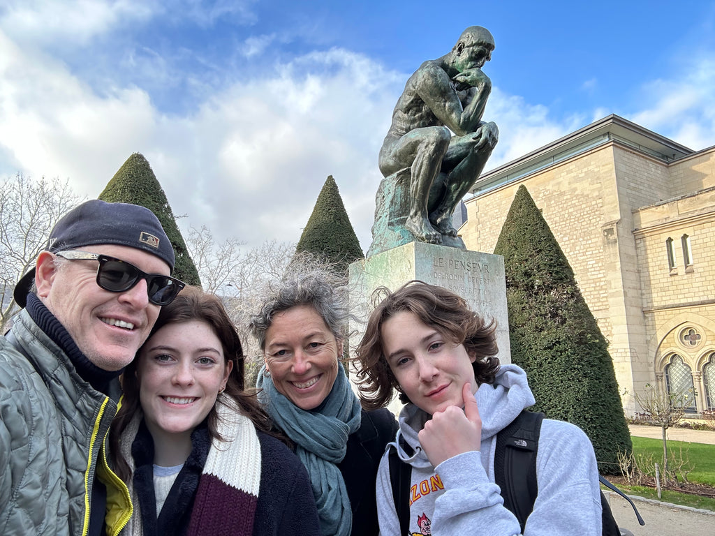 Mom, dad, and two teens in a French garden