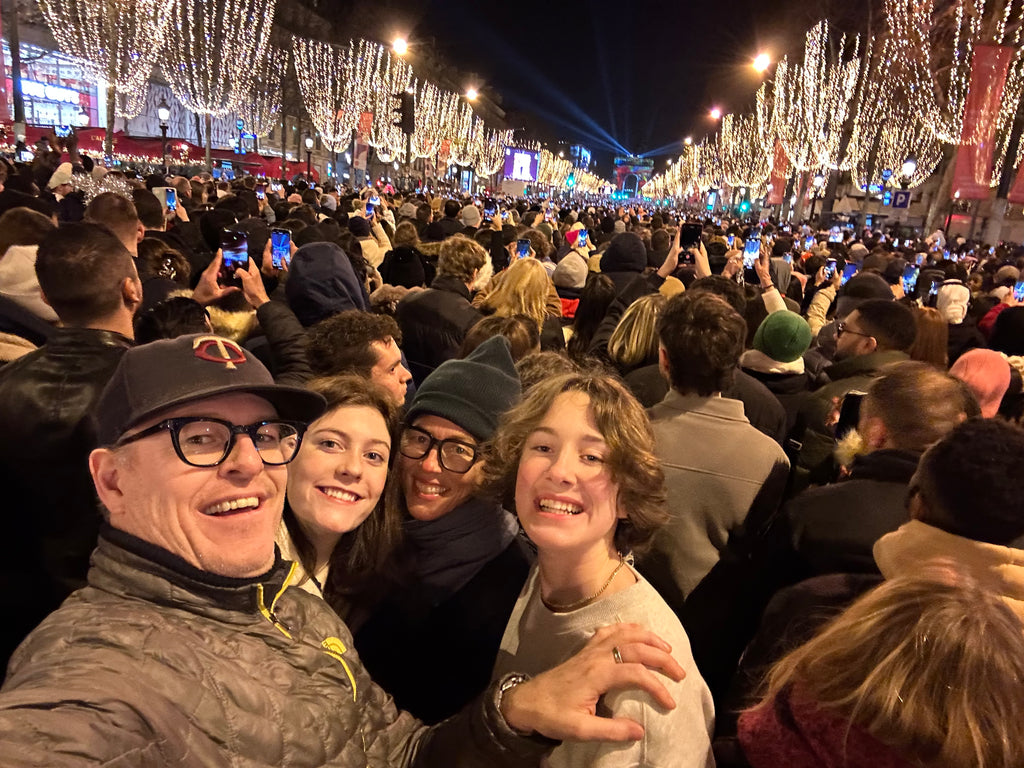 Mom, Dad, and two teens on the packed Champs-Élysées in Paris