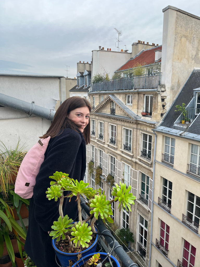Girl on patio overlooking a Paris street