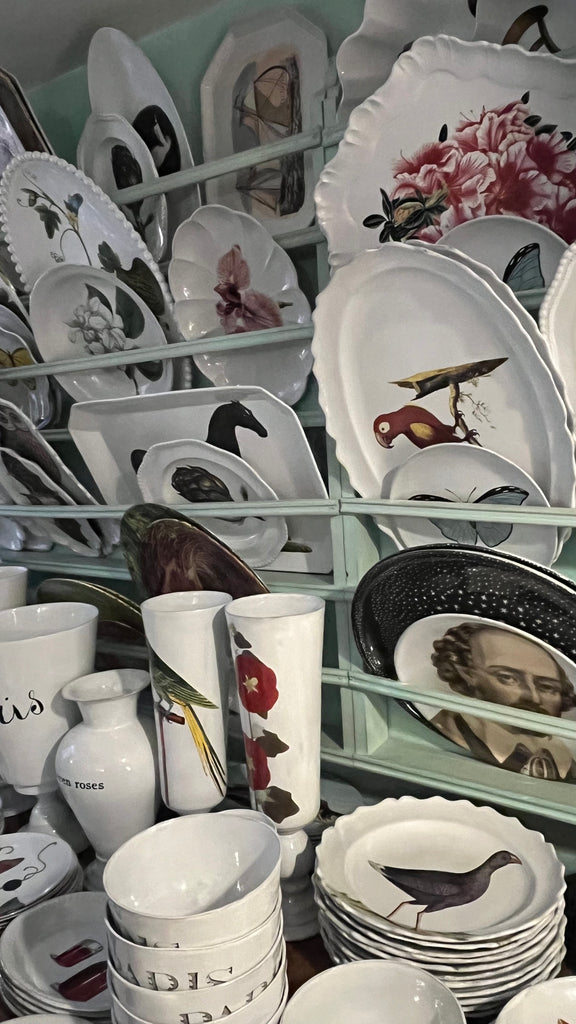 White bowls, trays, and plates with horses, flowers, and other designs painted on them