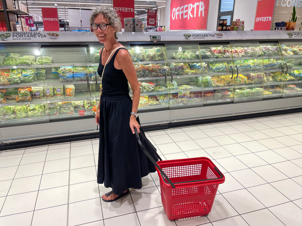 Woman pulling a grocery basket through an Italian supermarket