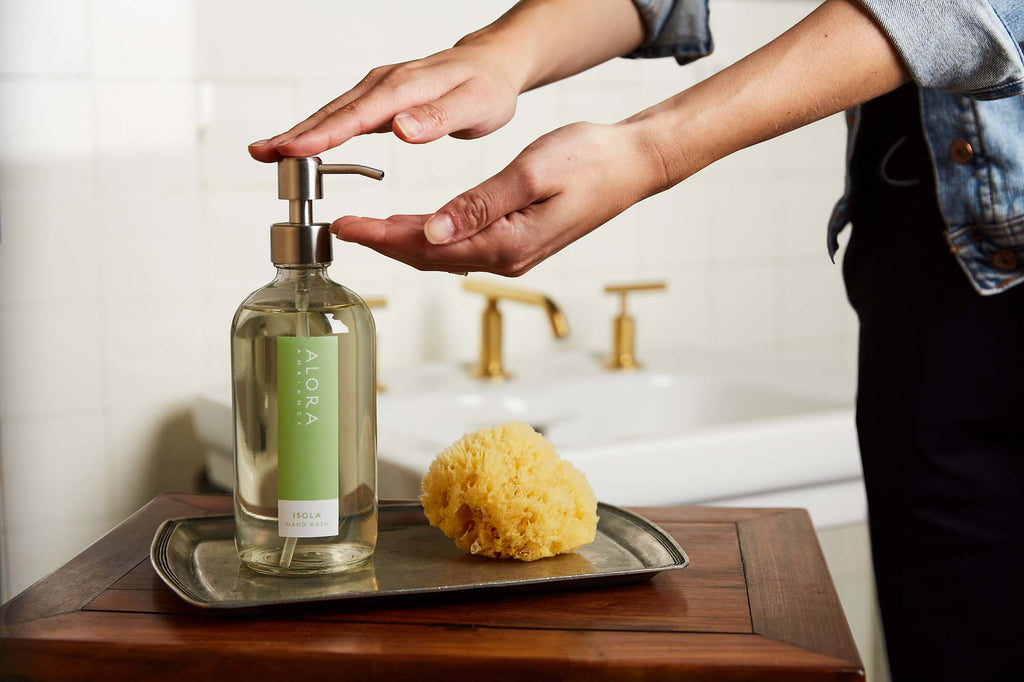 Person pumping Isola hand wash onto hands